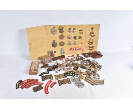 A MIXED SELECTION OF MILITARIA, to include a compass, cap badges, shoulder titles, belt buckles and a whistle, the compass is