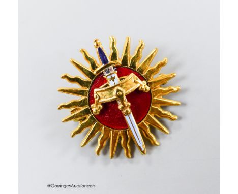   A modern 9ct gold and red enamel brooch, modelled as a sword and crown, with sun background, Garrard &amp; Co, London, 1990