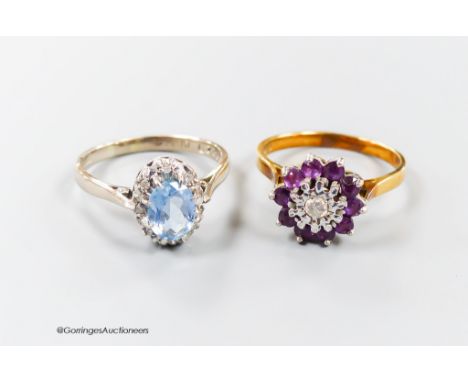   A modern 18th gold, aquamarine and illusion set diamond oval cluster ring, size R and one other 18ct gold, garnet? and diam