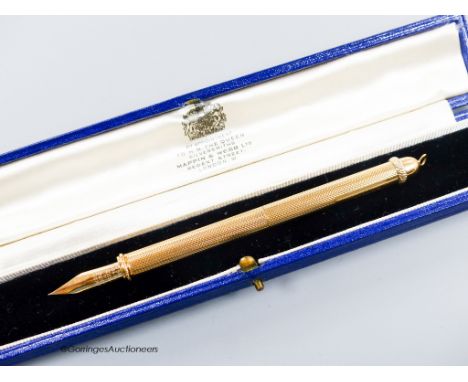   A 1960's engine turned 18k overlaid dip pen, with engraved inscription, 12.9cm, gross weight 24.4 grams.