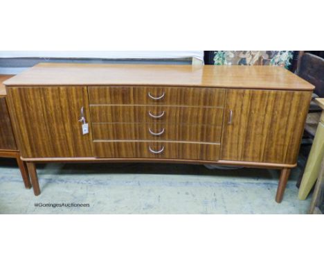   A Gordon Russell Ltd teak and Indian Laurel concave sideboard Model R810 circa 1960, length 183cm, depth 49cm, height 86cm
