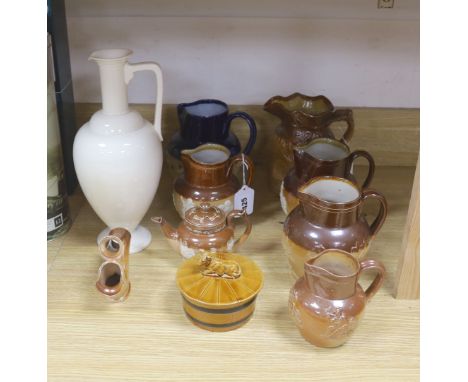   A group of Doulton stoneware: jugs, a teapot, butter dish and a pipe salesman's model