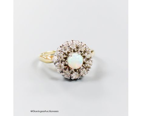   A modern 14k, white opal and illusion set diamond circular cluster ring, size L, gross 4.7 grams.