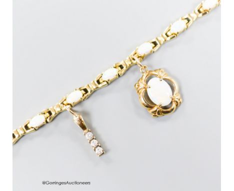   A modern 585 yellow metal and oval white opal set bracelet, hung with two yellow metal charms (white opal and three stone d