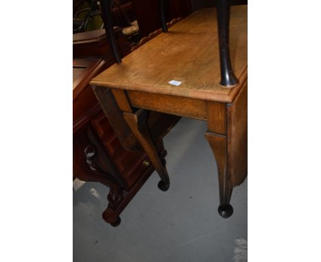 An early 20th century oval drop leaf gate leg dining table on pad feet . width approx. 90cm