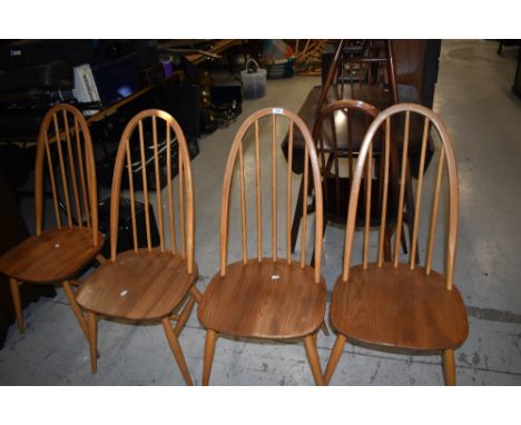 A set of four beech hoop and stick back kitchen chairs, labelled Ercol, mid to light colour