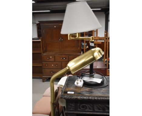 A modern standard daylight lamp and a modern swing arm table lamp