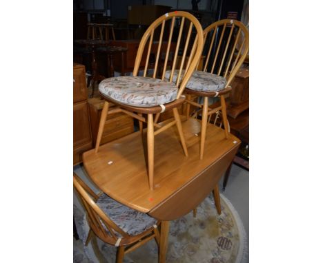 A light beech Ercol drop leaf dining tabe and set of four hoop and stick back dining chairs