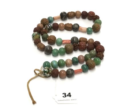 An interesting string of oriental glass and carved ceramic beads.