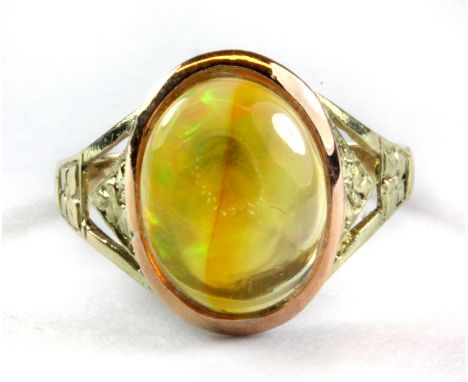 A yellow metal (tested minimum 9ct gold) ring set with a cabochon cut fire opal, (K.5).