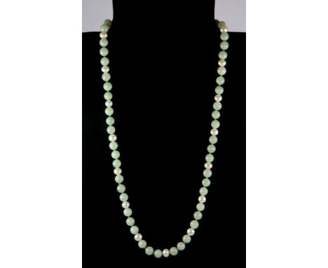 A jade bead and pearl necklace on a 14ct gold clasp.