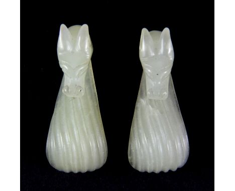 A pair of early 20th century pale celadon nephrite jade buckles with dragon head detail, L. 4.5cm.
