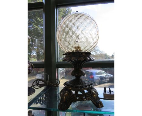 Gilt Metal table lamp with gilt metal base and blown glass globular shade   Measures approx 16 inches tall.  