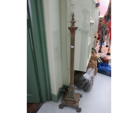 Victorian Brass Standard lamp raised on Lion paw feet, fluted Column on highly decorated brass base. Very heavy so must be co