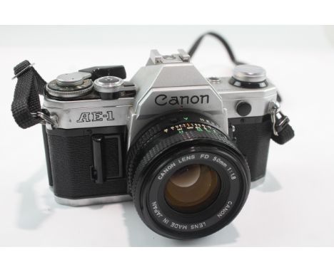 Canon AE-1 SLR Film Camera w/ Canon FD 50mm F/1.8 Lens This camera is WORKING and in a used condition The lens may require a 
