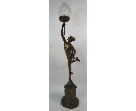 A Bronze alloy figure of Hermes with a frosted glass flame shade, standing on a cherub decorated plinth, requires rewiring to