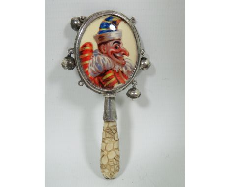 Childs Antique teether/Rattle, (two small bells missing)  Mr Punch enamel panel.  Measures approx 95mm long