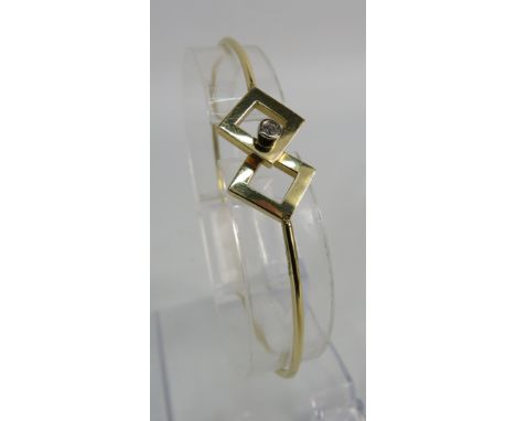 14ct gold bangle bracelet set with a 2.5 mm diamond, 6.9 grams.