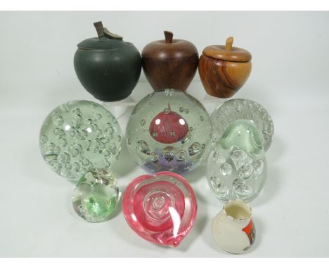 Selection of Controlled Bubble Paperweights plus Caithness pebble together with turned wood lidded pots and preserve jar. See