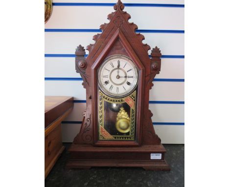 Gothic Style Mantle clock with enamelled face, glass pendulum door and wood frame. Comes with key and pendulum in working ord
