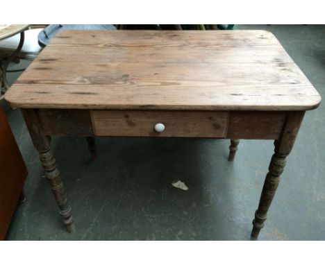 A Victorian pine kitchen table with single drawer and ceramic handle raised on turned legs, 64 x 98 x 78cmH