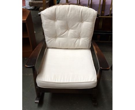 An Ercol stick back rocking chair with cushions