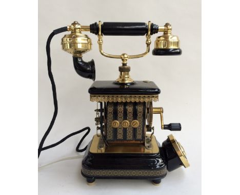 An antique Expoga of Danmark crank telephone with black enamel decoration highlighted in gilt, with gilt brass ear and mouth 