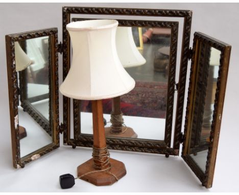 An Arts and Crafts table lamp and carved three piece dressing mirror, 60cmH