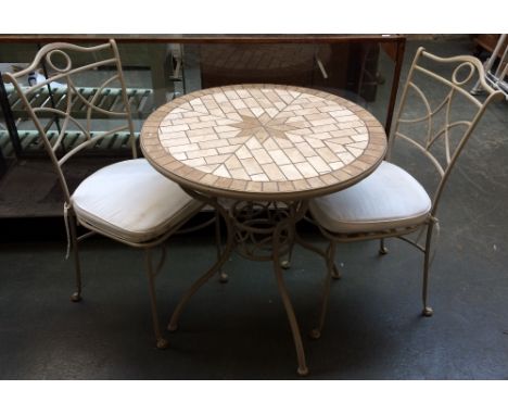 A metal garden table with mosaic tile top, 76cmD x 75cmH and two associated metal garden chairs with removable cusshion seats