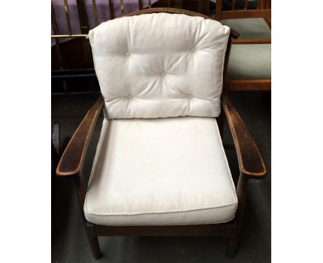 An Ercol stick back armchair with cushions