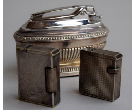 Two Dunhill lighters with textured finish, the first silver plate, 4.4cmH and the second, silver with hallmarks,  3.7cmH, alo