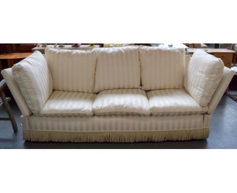 A knole three seater sofa upholstered in cream striped fabric