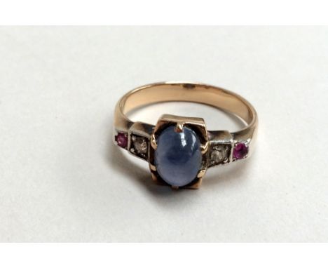 An Art Deco yellow metal ring with pale blue stone, diamond and ruby setting