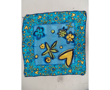 A Guy Laroche silk scarf with hand-rolled edges in vibrant blues and yellows. Good condition throughout. Measures 32" x 32". 