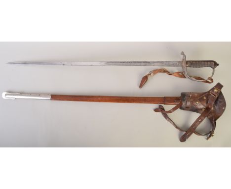 A 1897 pattern officer's sword inscribed on the blade and the hand guard with the crest of The Rifles, leather scabbard with 