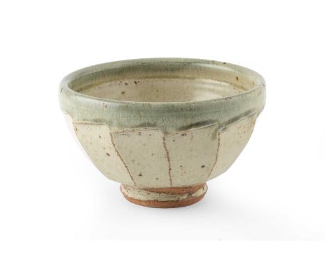 Richard Batterham (1936-2021) Footed bowl the body with green ash glaze and cut sides11cm high, 18cm diameter.