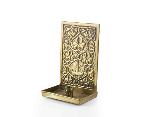 Keswick SchoolArts & Crafts candleholderembossed brass22cm high.Dent to front left of tray meaning holder does not sit flat. 