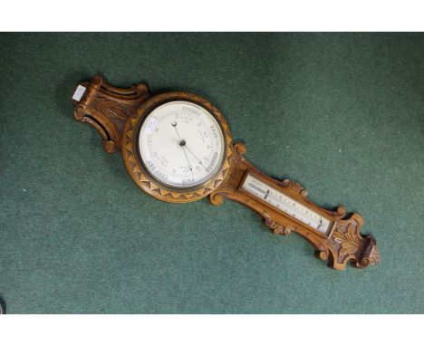Edwardian oak cased barometer/thermometer, with scroll and acanthus leaf carved decoration, 89cm x 26.5cm max