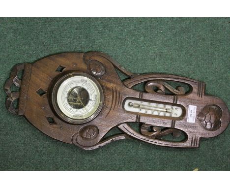 German walnut cased baromoeter/thermometer, with pierced scroll carved frame, 20cm x 48cm