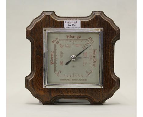 SB barometer with silvered dial, mounted in a shaped oak frame, 20.5cm square