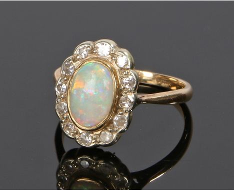 Diamond and opal ring, the oval opal with a diamond surround, ring size M