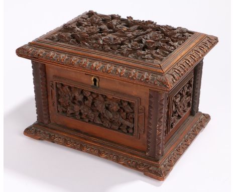 19th century Black Forest jewellery casket, deeply carved with flowers and branches, conforming carved panels to the surround