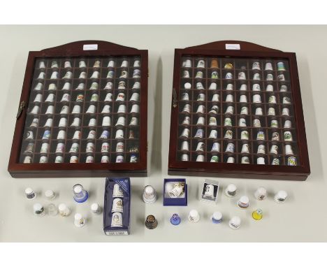 A collection of mainly ceramic thimbles in two display cases, together with a quantity of loose and boxed thimbles, (Qty)