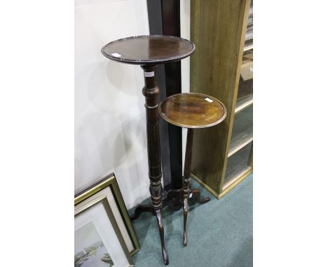 Two mahogany torchere stands, with reeded stems, on tripod legs, 111cm and 81cm high (2)