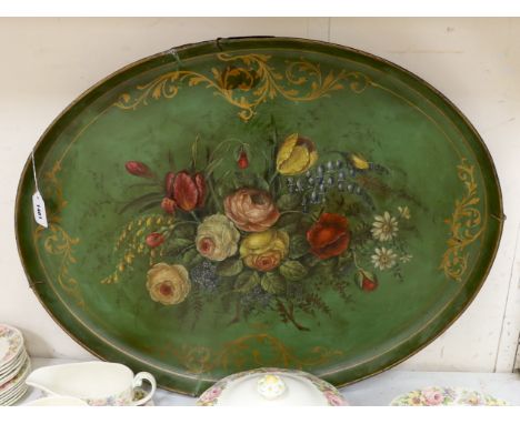 A large 19th century papier maché tray, painted with floral still life, 76cm wide Five cracks inward from rim, longest approx