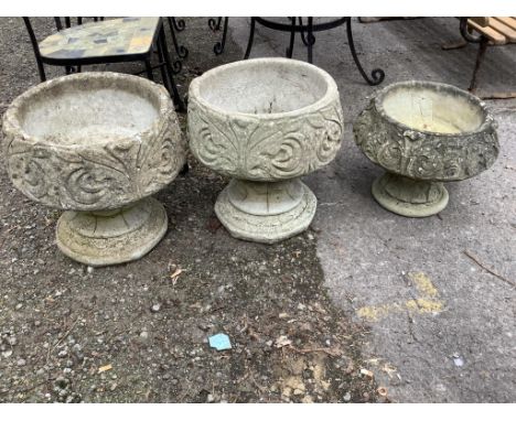 A pair of circular reconstituted stone garden planters, diameter 42cm, height 42cm together with a similar smaller planter