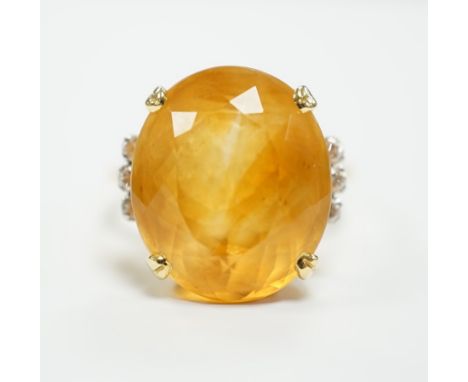 An 18k and single stone oval cut citrine set dress ring, with six stone diamond set shoulders, size R, gross weight 8.3 grams