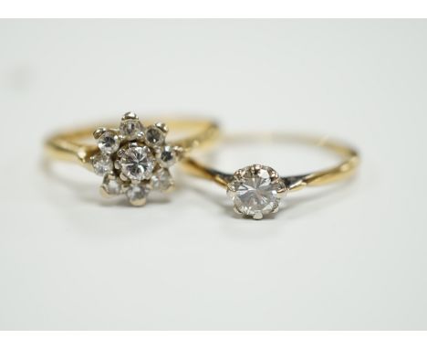 An 18ct gold and diamond cluster set flower head cluster ring, size K and an 18ct, plat. and solitaire diamond set ring, size