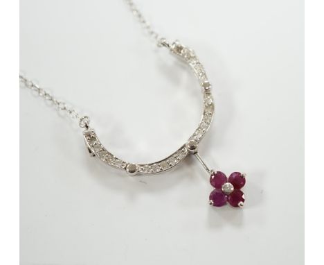 A modern 14ct white gold, ruby and diamond cluster set metamorphic pendant, 21mm, on a 14k white metal fine link chain, 38cm,