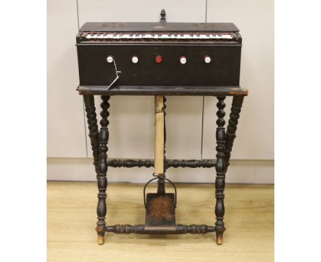 An Indian single bellow portable harmonium, with turned ebonised stand and foot pedal, 75.5cm high, 54.5cm wide Bellows teste